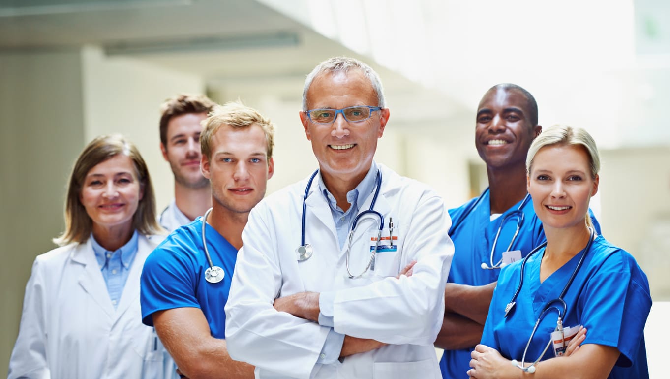 group of medical professionals smiling with their arms folded