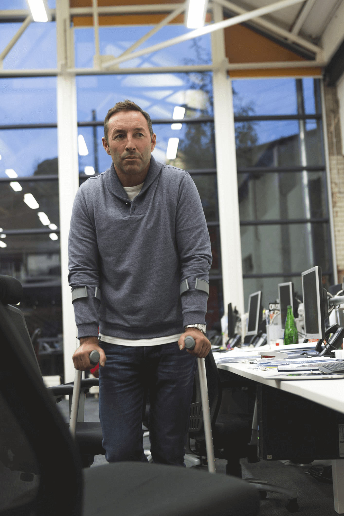 person with severe spasticity walking in an office