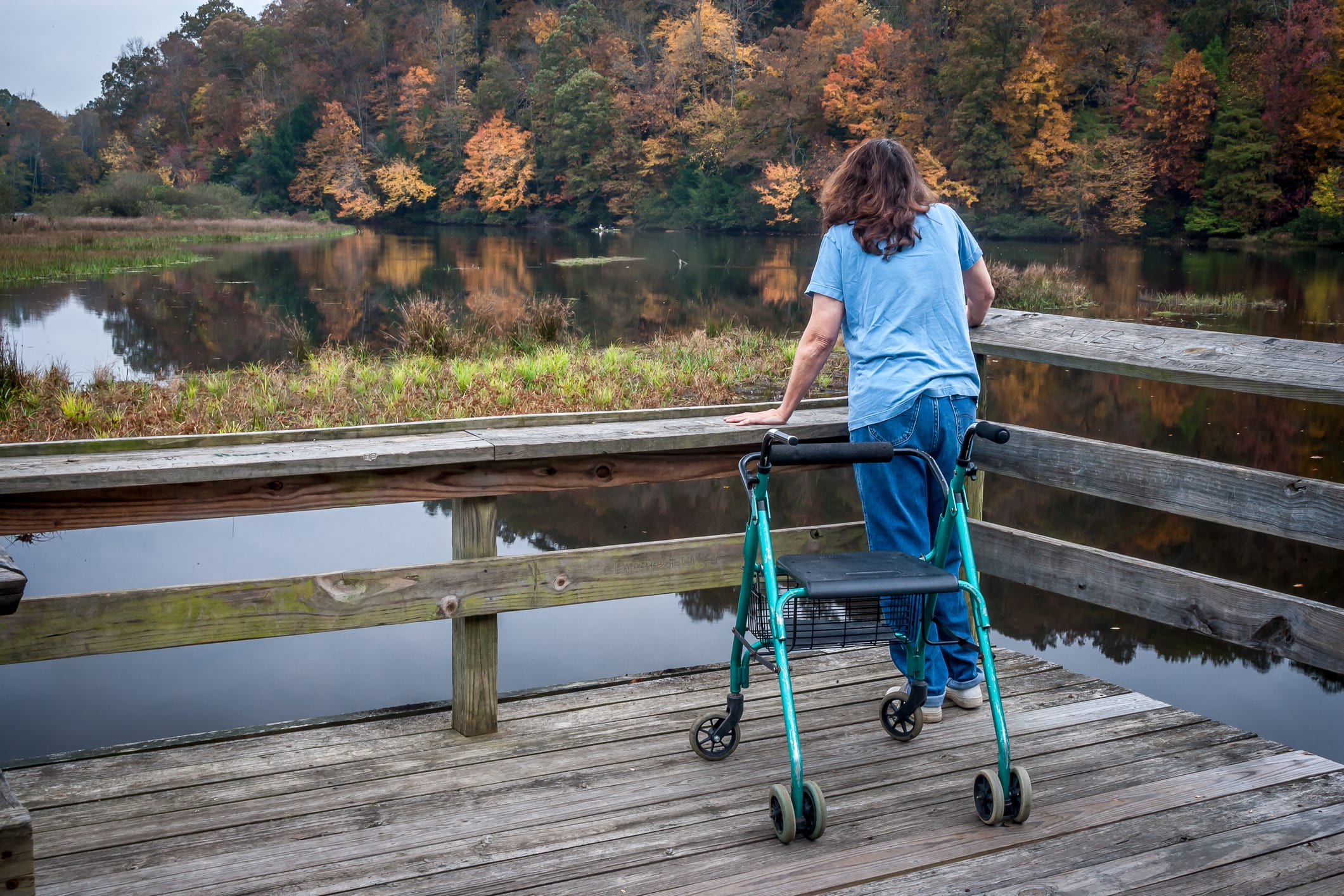 woman with multiple schlerosis on a deck overlooking a lake