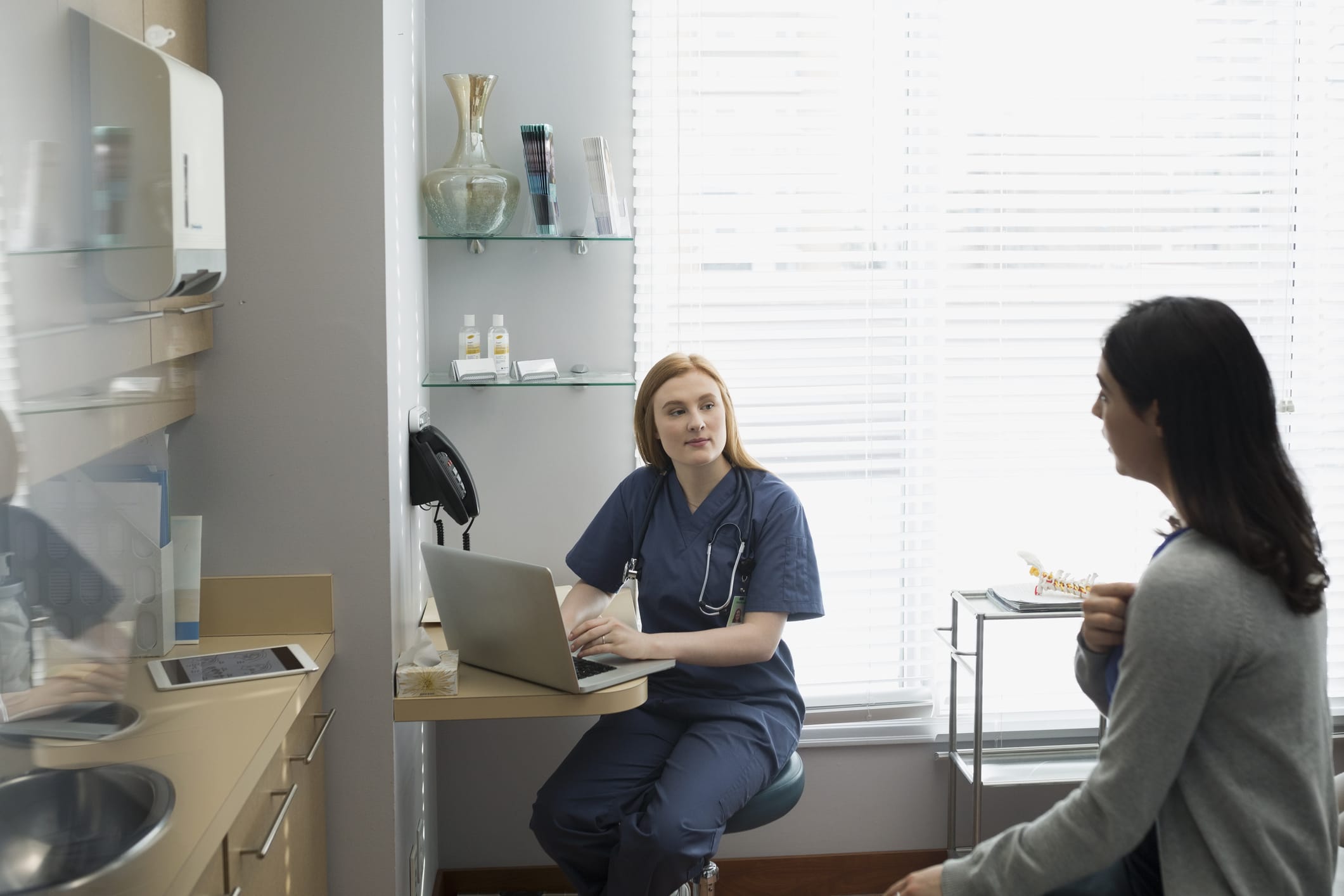 patient and doctor talking in a doctor office