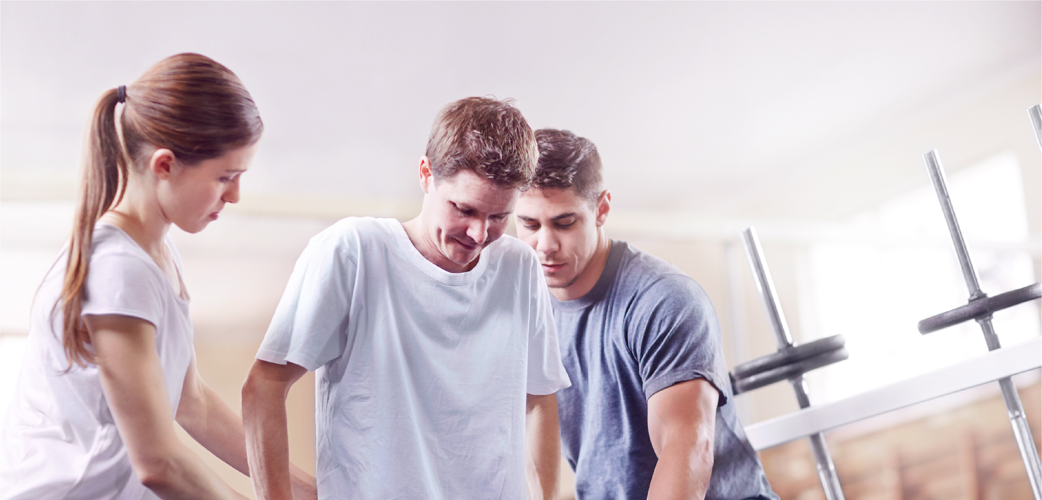 two physical therapists assisting a patient